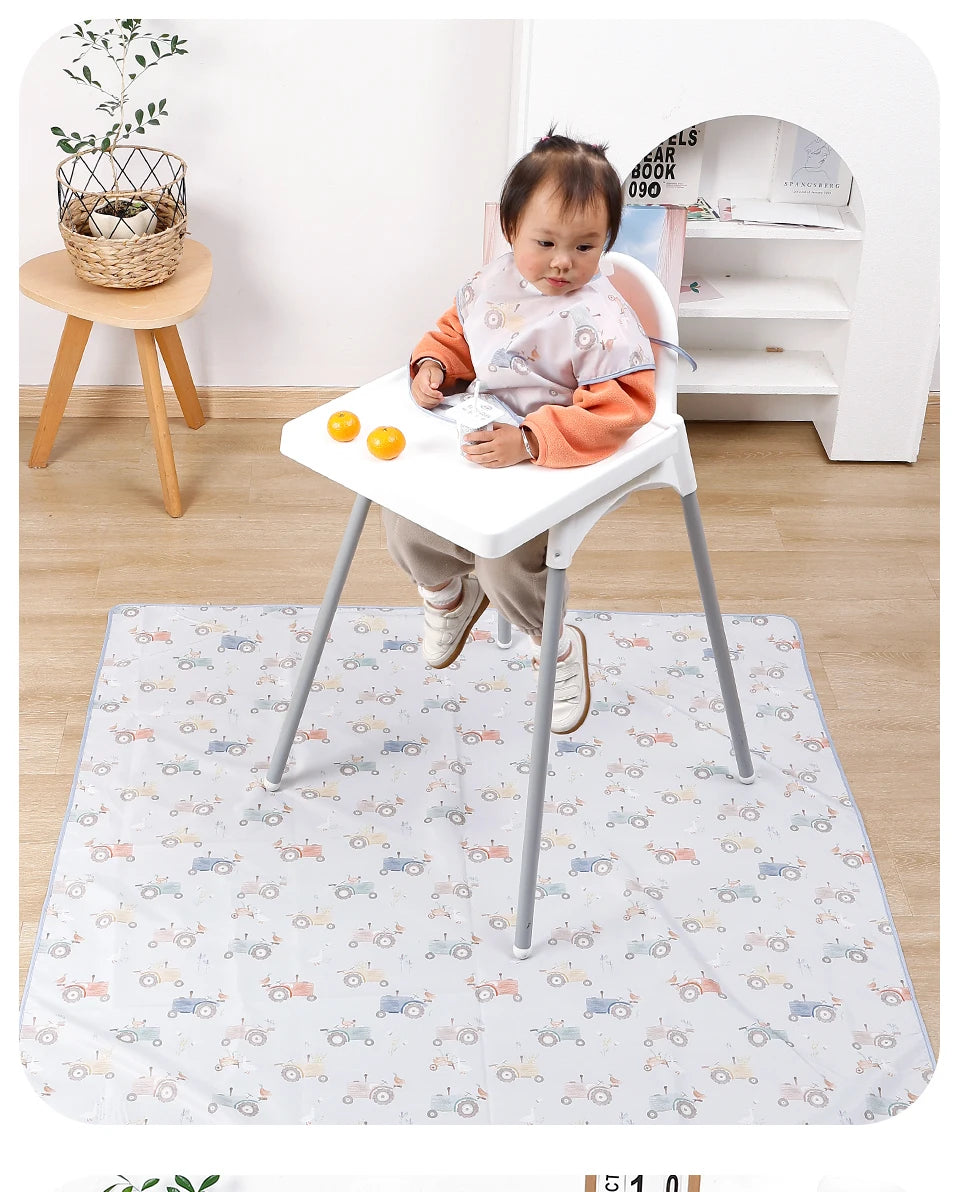 A baby is sitting on a white play mat with various toy cars and accessories.