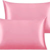 A stack of pink silky satin toddler pillowcases.