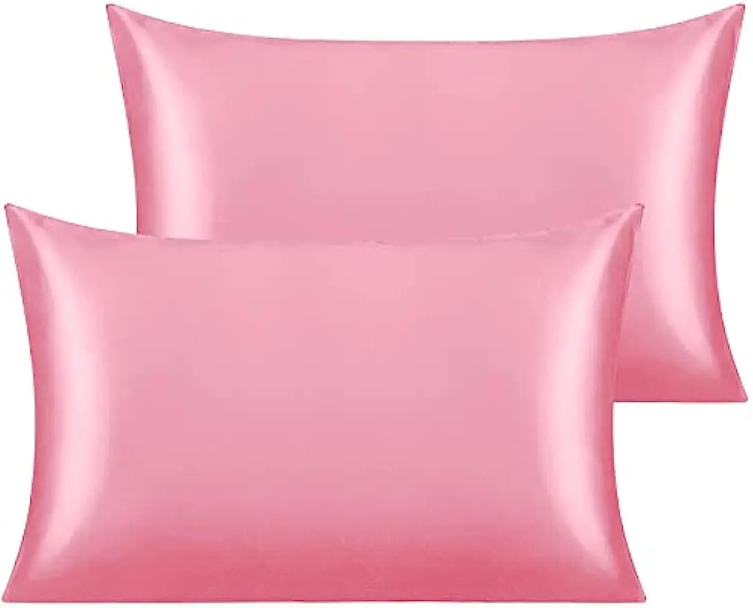 A stack of pink silky satin toddler pillowcases.