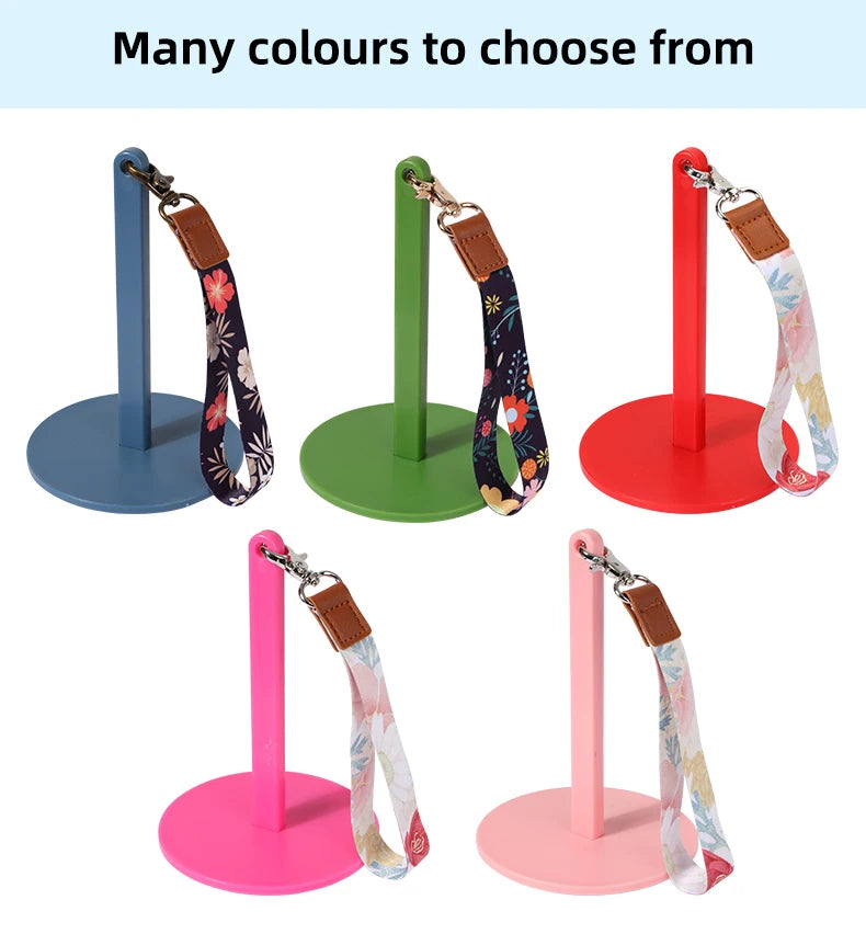 A set of adjustable yarn holders and winders in various colors including blue, green, red, and pink.