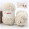A pair of fluffy, light beige coral velvet yarn balls for crafting.