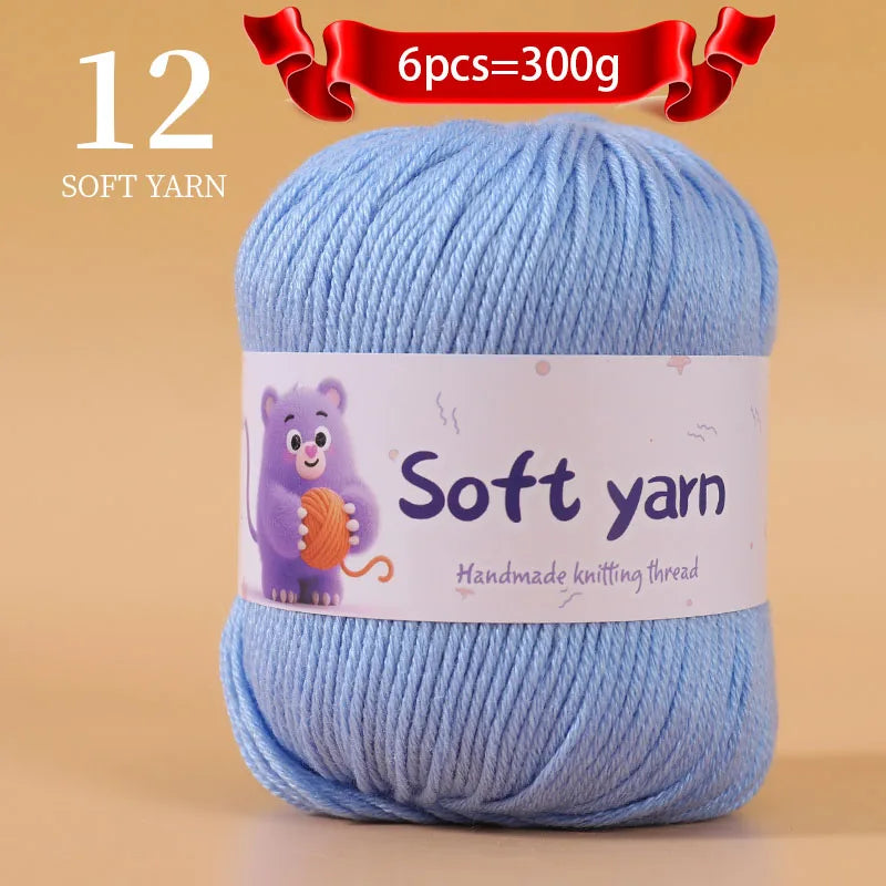 A ball of light blue soft yarn labeled as 12 soft yarn, with a note indicating 6 pieces equal 300g.