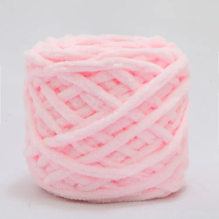 A ball of pink soft chenille knitting yarn for hand crafting