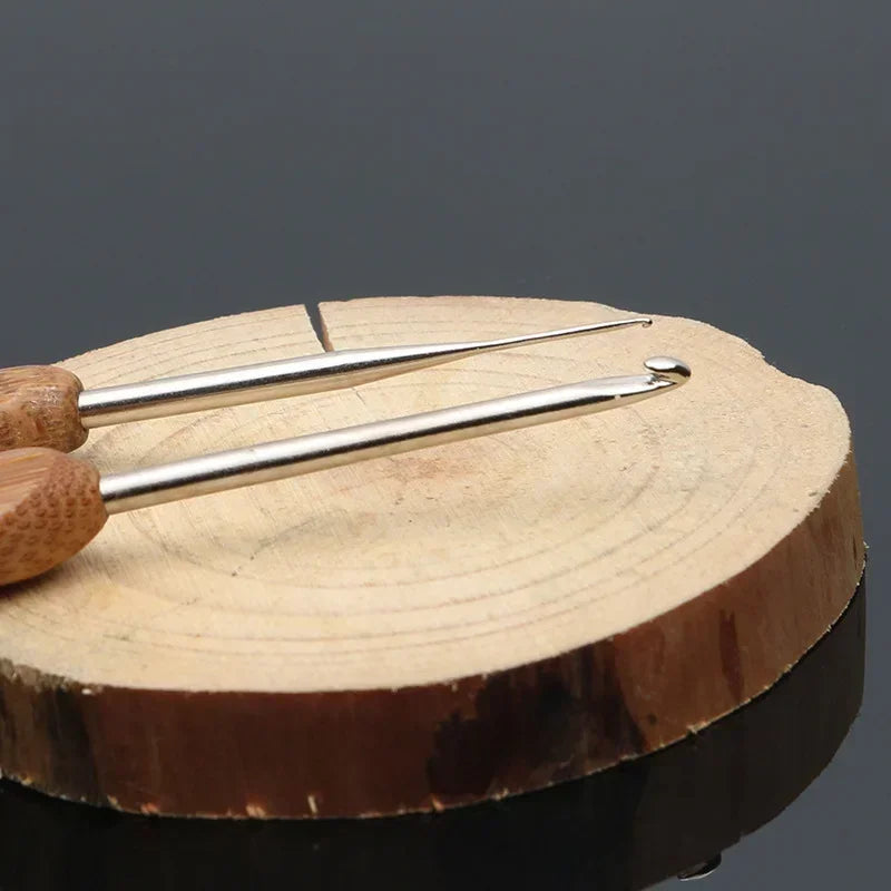 A set of bamboo crochet knitting needles resting on a wooden surface.