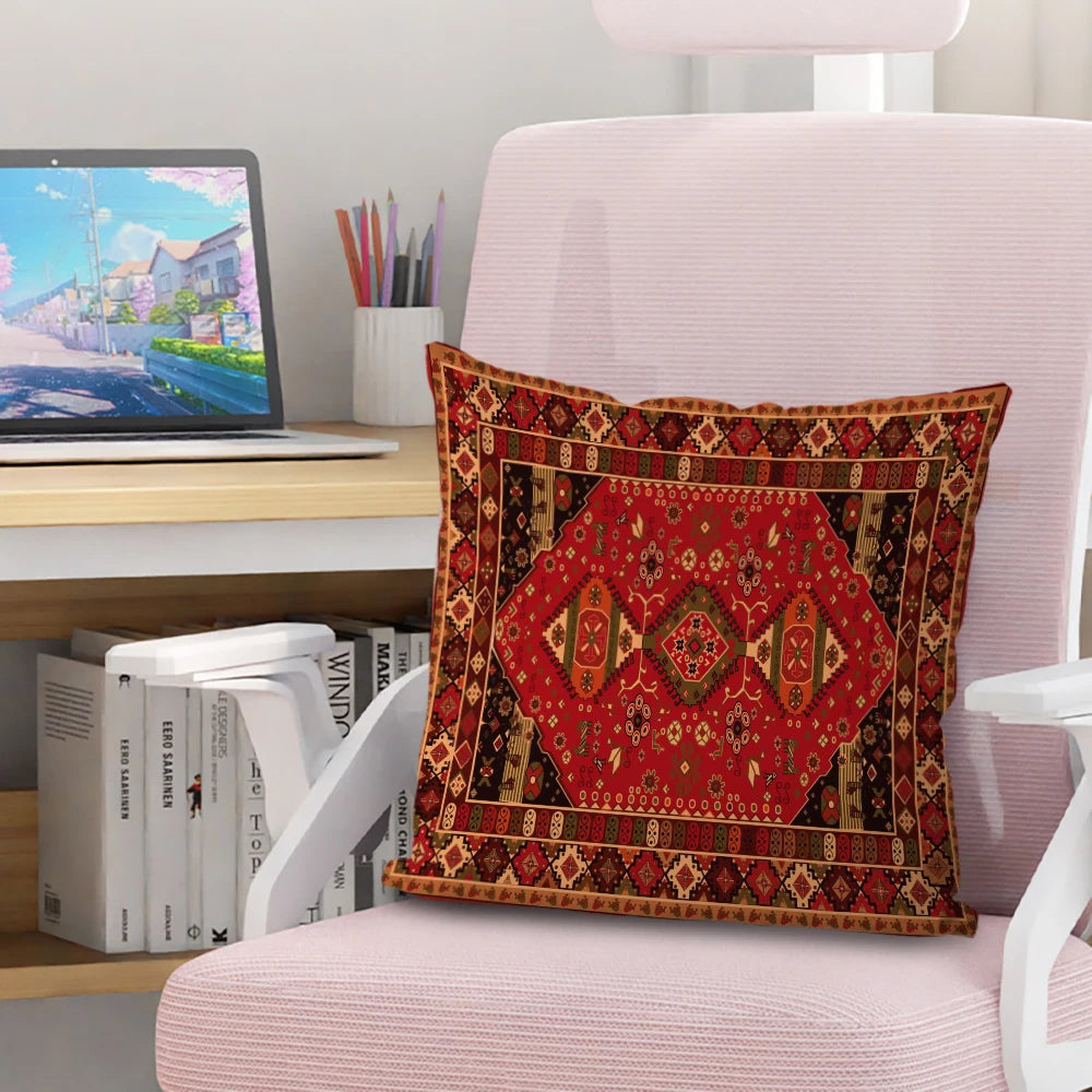 A square decorative cushion cover featuring a rich red and gold Persian pattern on a pink upholstered chair.