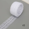 A roll of white floral lace ribbon with a cotton trim for sewing and crafts.