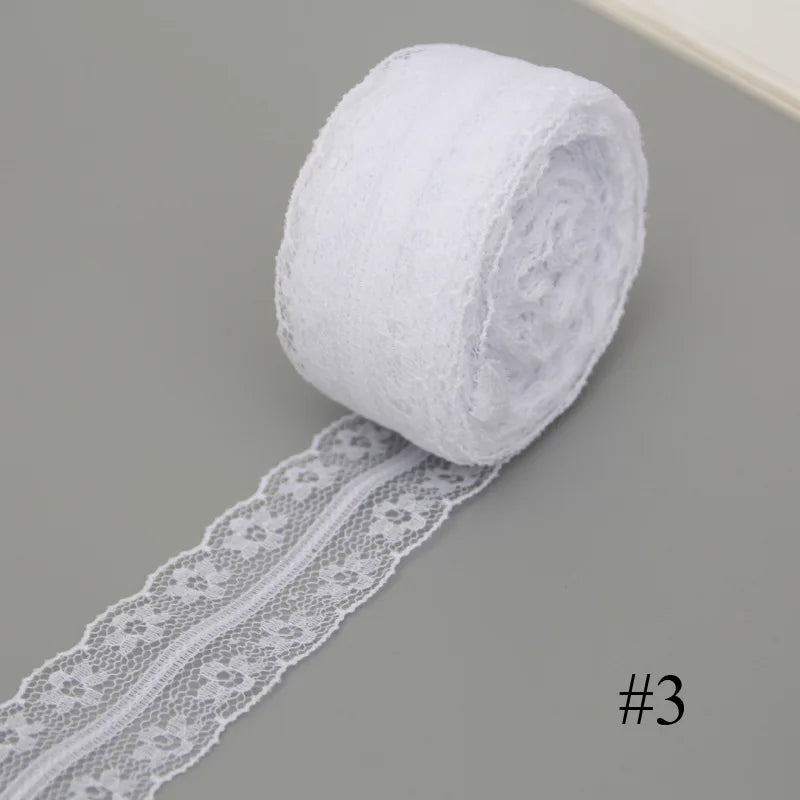 A roll of white floral hollow-out lace ribbon for sewing and DIY crafts.