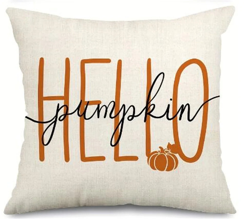 A beige pillow cover with the word HELLO and the word pumpkin written in orange script.