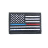 A black flag patch featuring the design of the American flag with horizontal stripes and a canton.