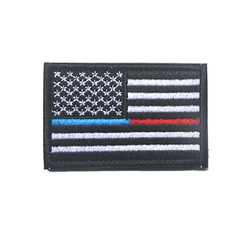 A black flag patch featuring the design of the American flag with horizontal stripes and a canton.