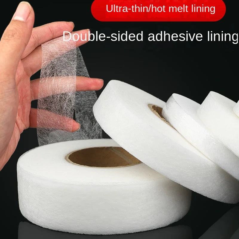 A hand is applying ultra-thin hot melt lining double-sided adhesive tape to a roll of white fabric tape.