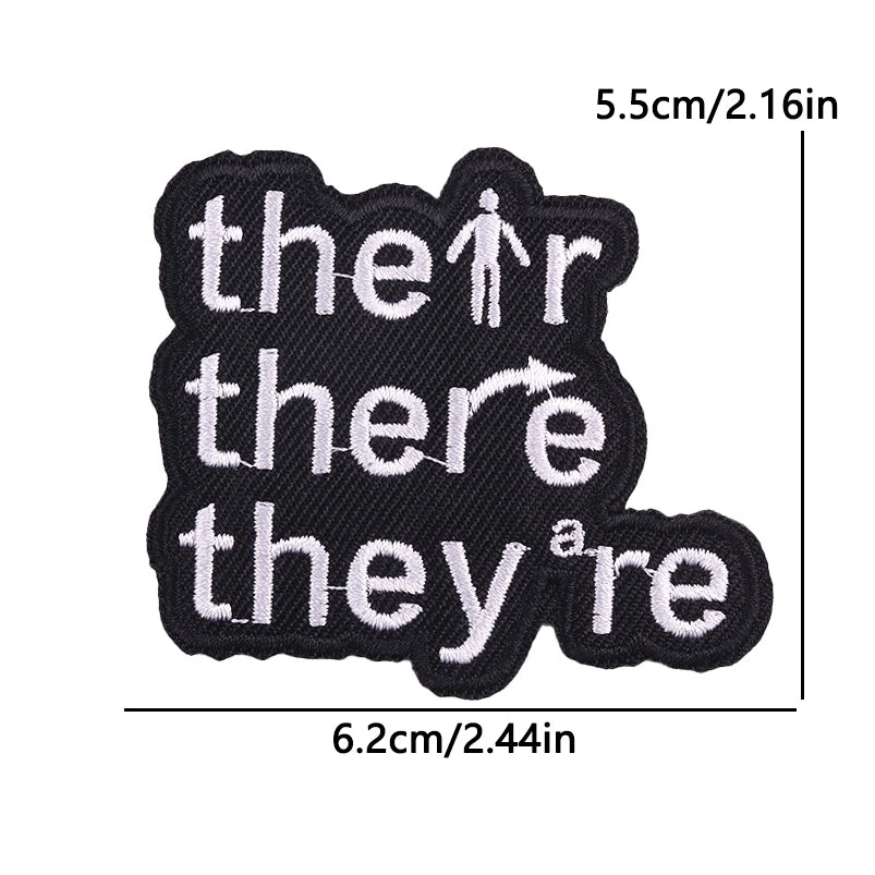 Black iron-on embroidery patches with the text there they are stitched in white thread