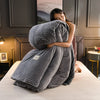 A woman is relaxing on a bed covered with an ultra-soft corduroy duvet cover set.