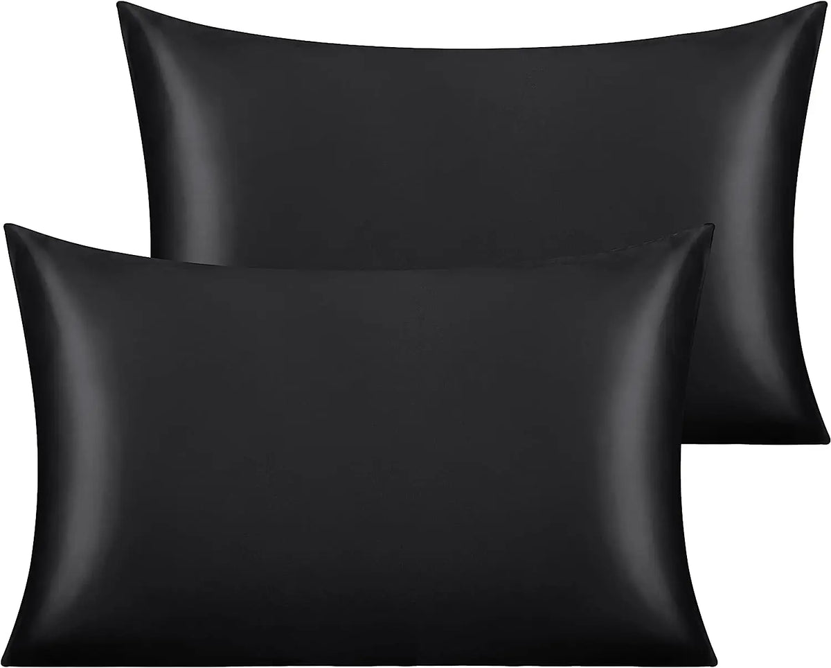 A set of two black silky satin toddler pillowcases.