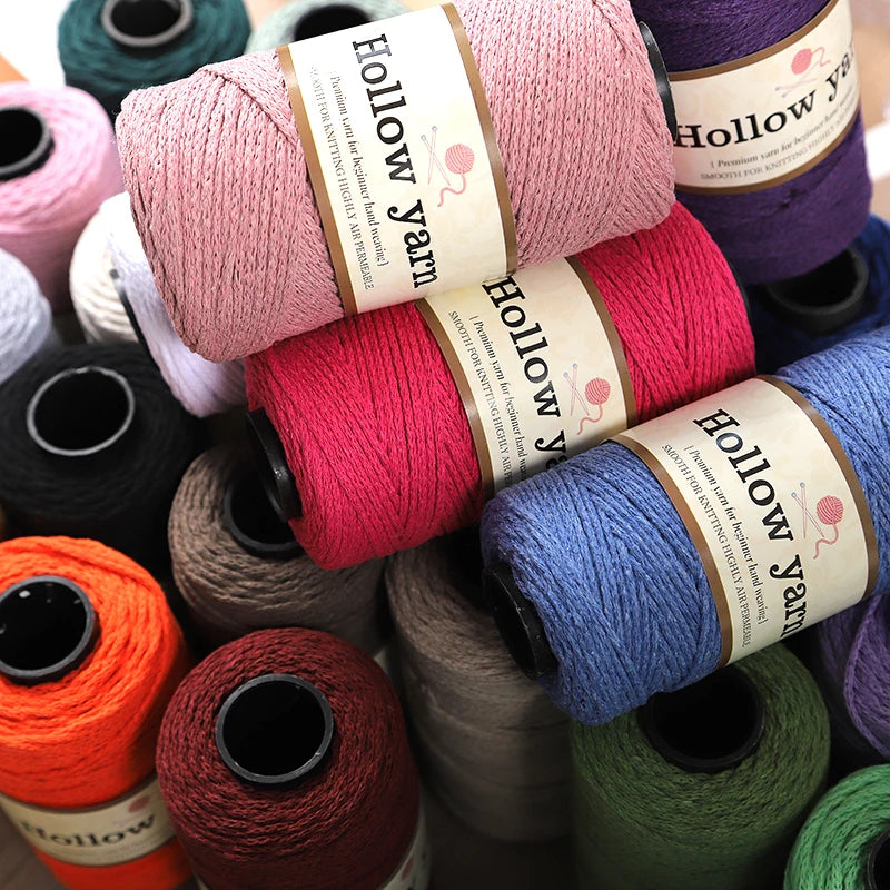 A collection of various colored Hollow Yarn spools for knitting and crochet projects.