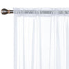 Modern sheer white curtain with a rod pocket hanging in a window.