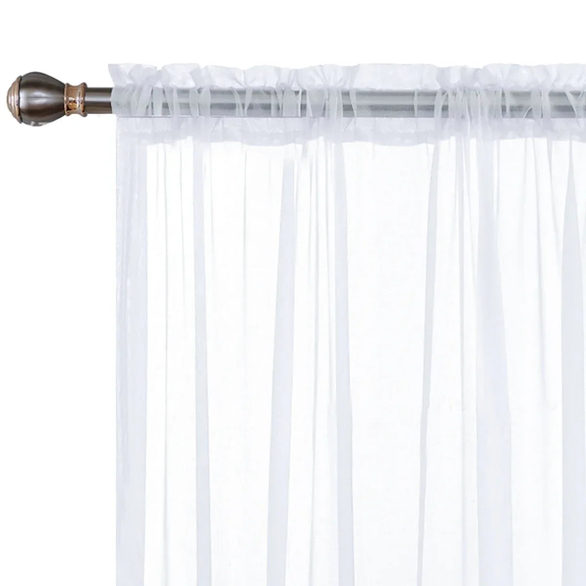Modern sheer white curtain with a rod pocket hanging in a window.