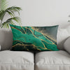A square accent pillow cover featuring a marbled teal green and gold geometric pattern.