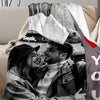 A couple smiling while looking at a map on a custom photo personalized flannel blanket.