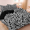 A leopard print duvet cover set featuring black and white spots on a bed.