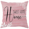 A pink decorative pillow cover featuring black script text that reads Sweet Home.