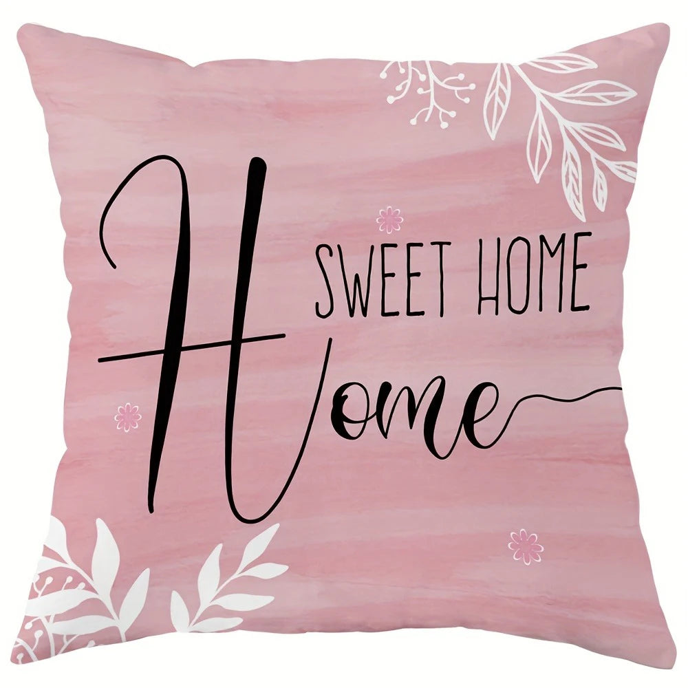 A pink decorative pillow cover featuring black script text that reads Sweet Home.