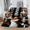 A black and white graphic throw blanket featuring multiple portraits of Eminem.
