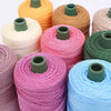 A collection of colorful crochet ice rope spools in shades of orange, pink, green, and blue.