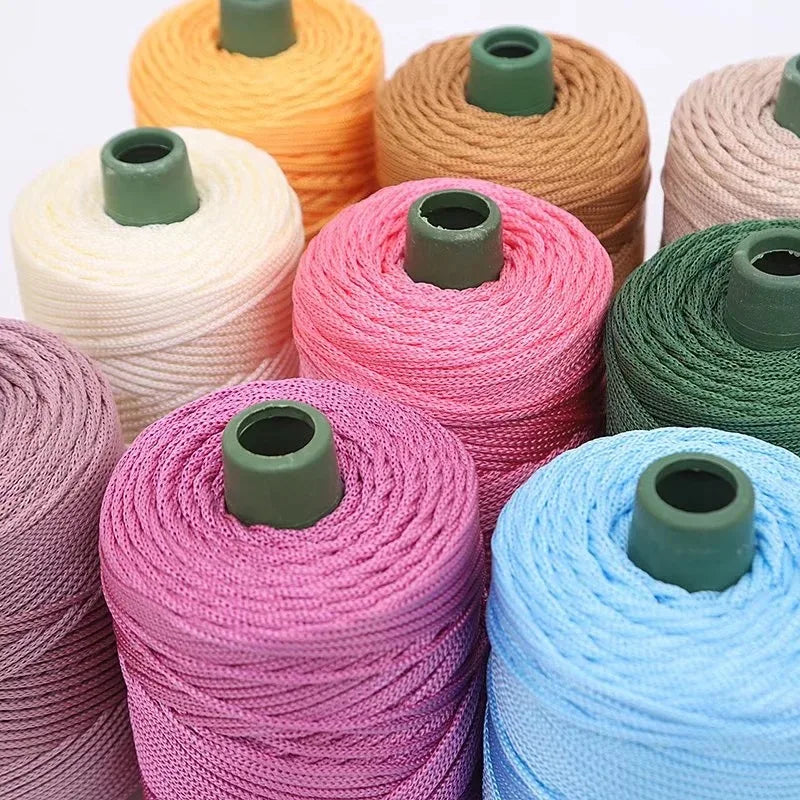 A collection of colorful crochet ice rope spools in shades of orange, pink, green, and blue.