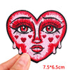 A red embroidery patch depicting a heart-shaped face with pink skin, red lips, and prominent eyelashes.