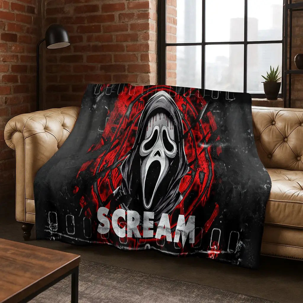 A dark flannel throw blanket featuring a distressed, screaming horror character design in red and white.