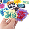 A hand holds a purple iron-on embroidered patch that reads Have a Great Day