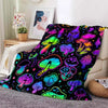 A colorful flannel throw blanket featuring a vibrant pattern of various stylized mushrooms against a black background.
