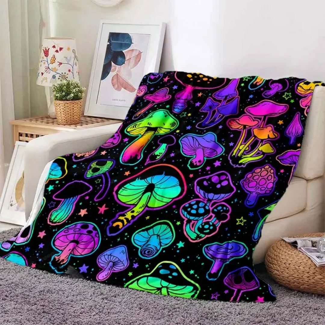 A colorful flannel throw blanket featuring a vibrant pattern of various stylized mushrooms against a black background.