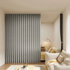 A modern gray pleated fabric room divider curtain in a minimalist interior setting.