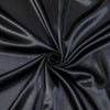 Black satin luxury bedding fabric tightly rolled to show its smooth texture and sheen.