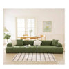 A modern, olive green stretchable full-wrap sofa slipcover in a bright, minimalist living room.