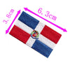 Embroidery patch of the Dominican Republic flag featuring red, white, and blue stripes and a central emblem.