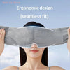 A woman is wearing a gray seamless ergonomic design sleep mask for deep relaxation.