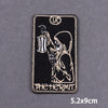Black embroidered patch featuring a stylized hermit figure and initials LK on a dark background