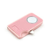 A pink magnetic seam guide with a silver circular gauge for sewing projects.