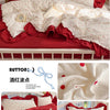Red and white princess style ruffle bedding set with decorative pillows on a white wooden bed.