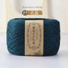 A ball of dark teal bamboo fiber yarn labeled as 19 threads for crafting.