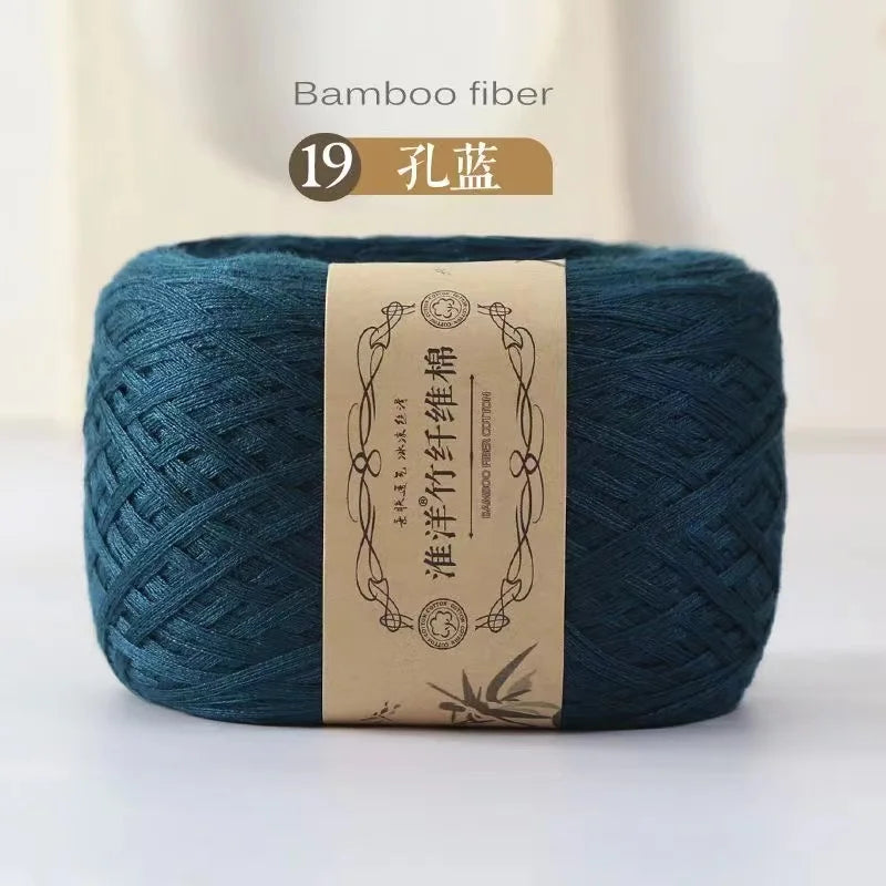 A ball of dark teal bamboo fiber yarn labeled as 19 threads for crafting.