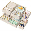 A beige wooden organizer set containing various folded underwear and clothing items.