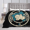 A black throw blanket featuring a light blue sleeping face design on a circular background.