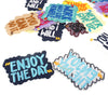 A collection of colorful iron-on embroidered text patches featuring motivational phrases like I will and you can do it
