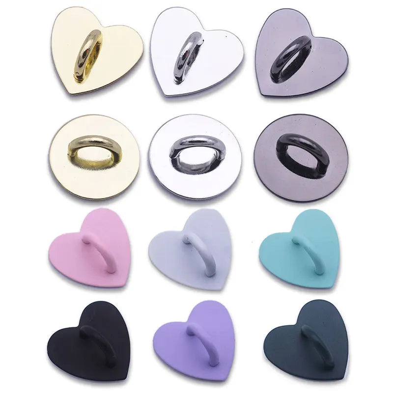 A collection of metal heart-shaped phone charm connectors in various colors including gold, silver, purple, and black.