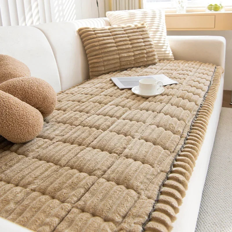 A beige corduroy sofa armrest cover with quilted texture resting on a white sofa.
