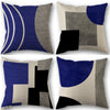 A set of four abstract geometric throw pillow covers in shades of navy blue, black, gray, and beige.
